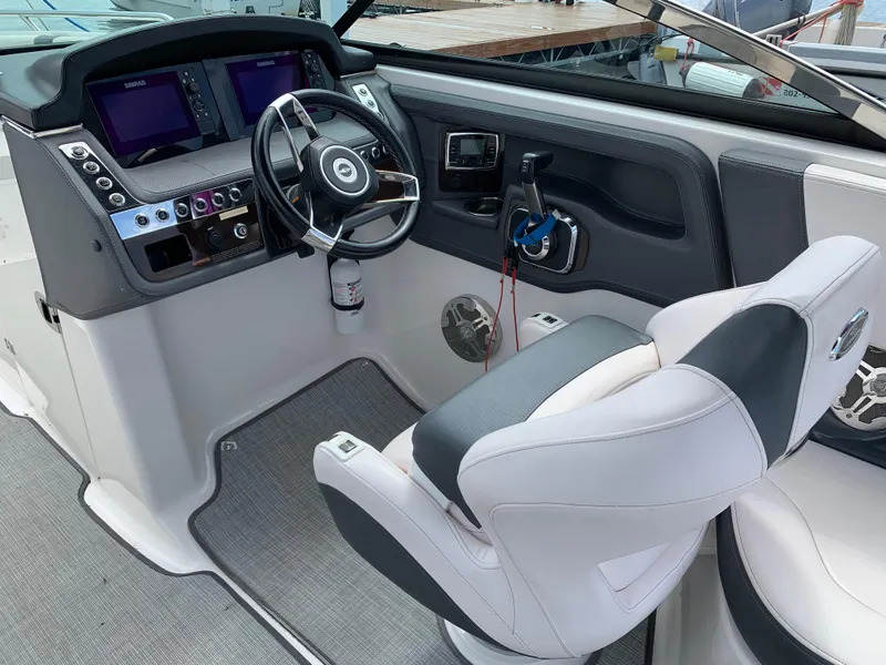 Slide: The Image of 2019 Chaparral 257 SSX boat cockpit with modern steering and control panel. - 38