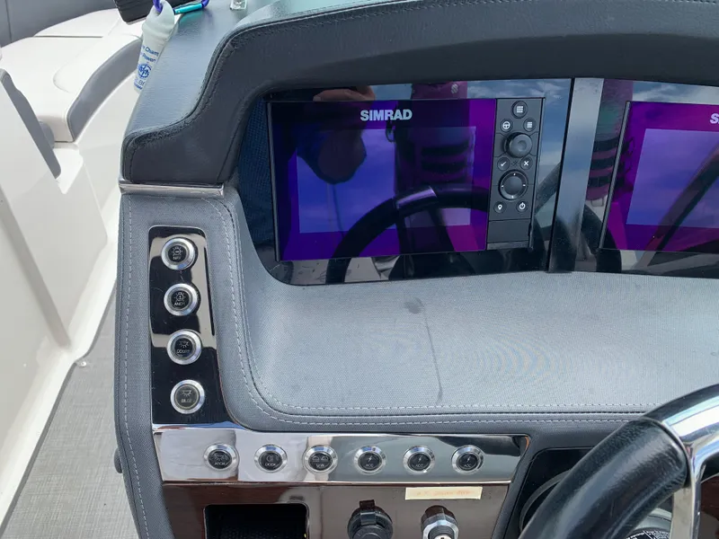 Slide: The Image of 2019 Chaparral 257 SSX dashboard with Simrad display and control buttons. - 40