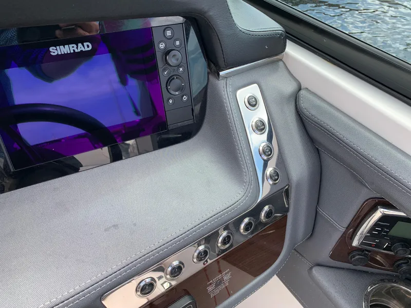 Slide: The Image of Control panel of 2019 Chaparral 257 SSX boat with Simrad display and buttons. - 41