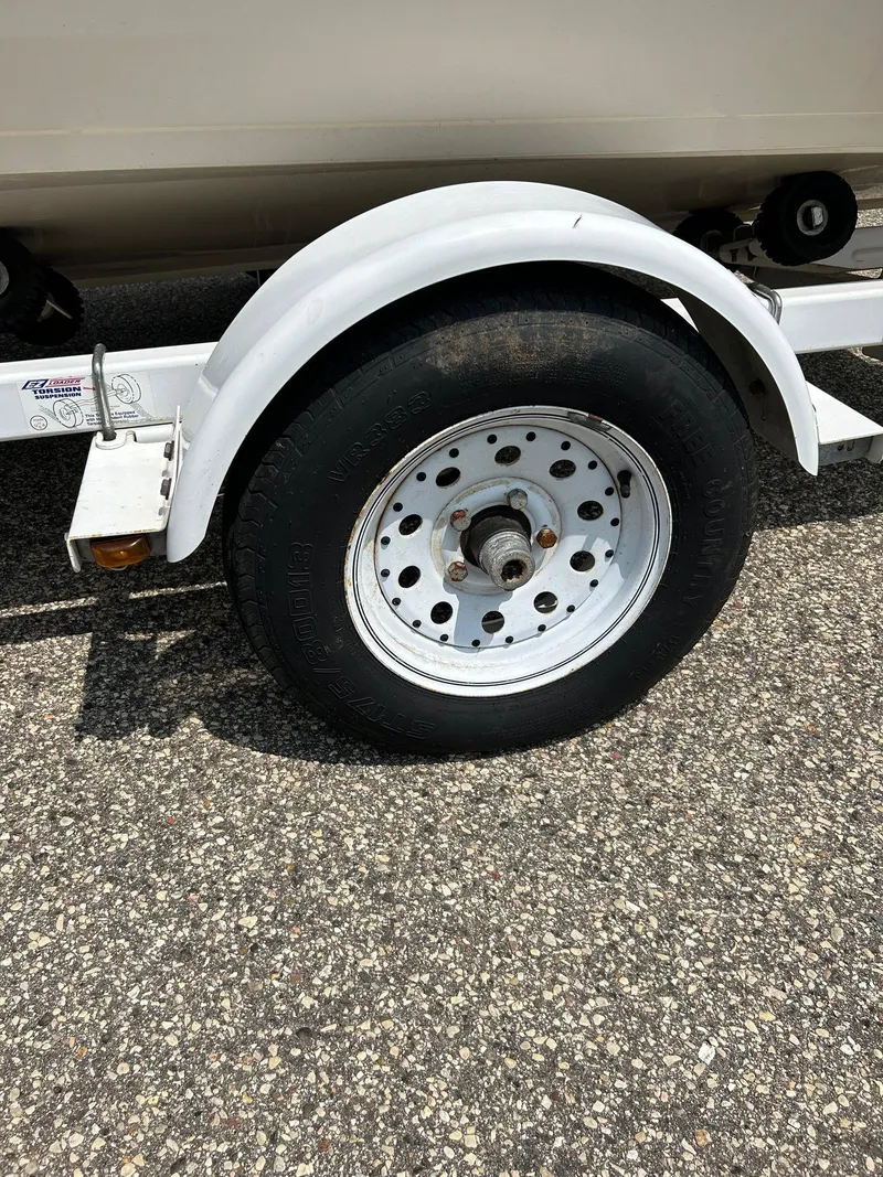 Slide: The Image of Trailer wheel of a 1997 Crestliner 1650 Sportfish on asphalt. - 10