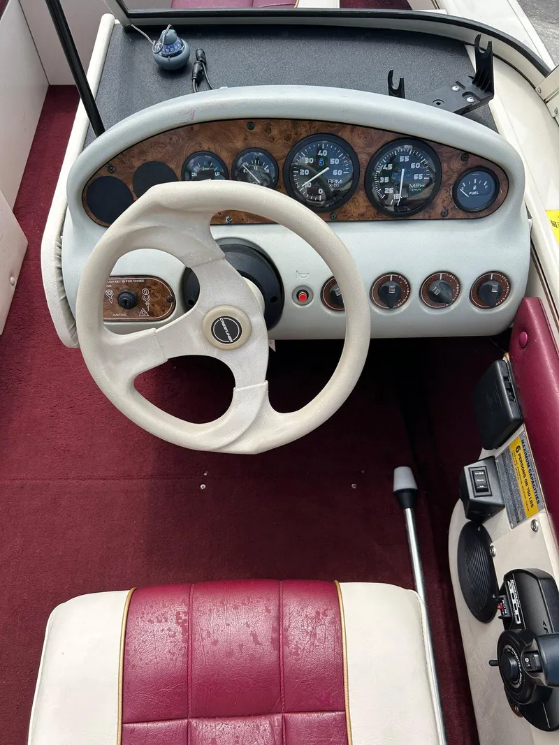 Slide: The Image of 1997 Crestliner 1650 Sportfish boat dashboard with steering wheel and gauges. - 3