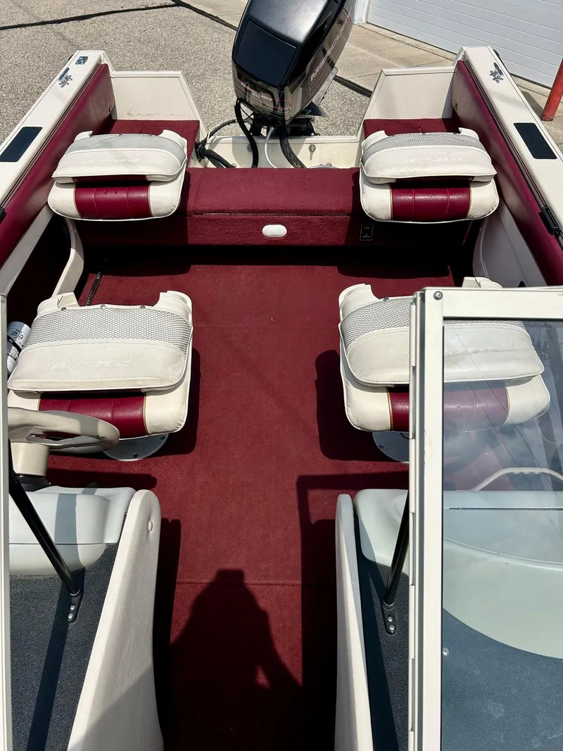Slide: The Image of 1997 Crestliner 1650 Sportfish boat interior with red carpet and white seats. - 7