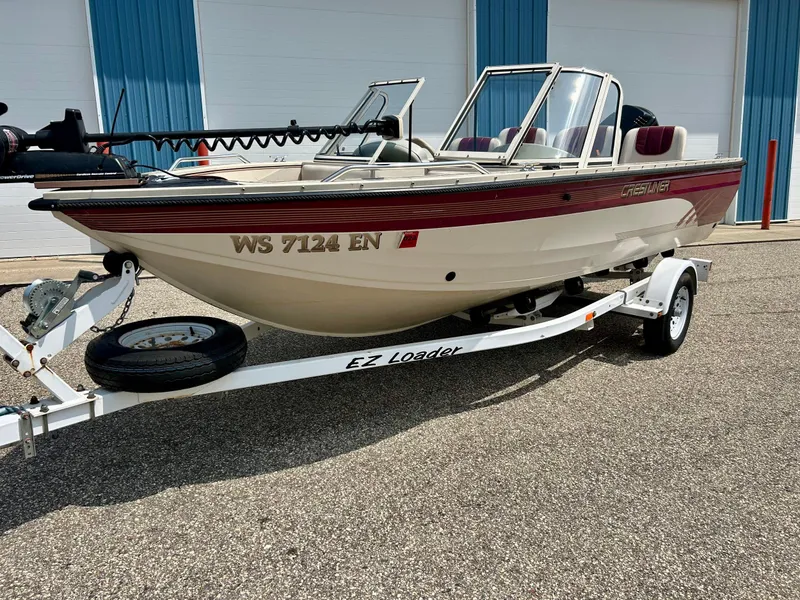 Slide: The Image of 1997 Crestliner 1650 Sportfish boat on EZ Loader trailer, parked outdoors. - 9