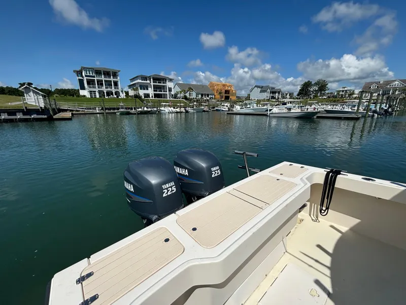 Slide: The Image of 2005 Parker 2501 Center Console boat with Yamaha 225 engines docked in a marina. - 11