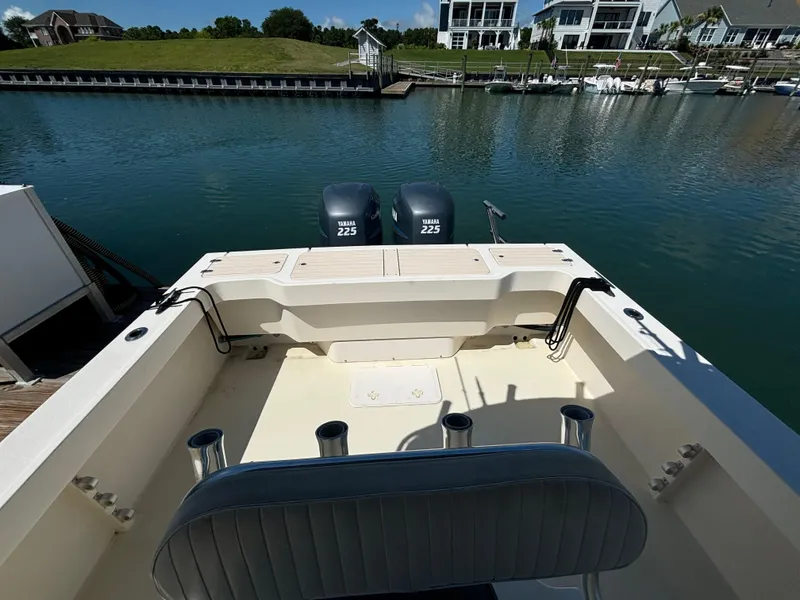 Slide: The Image of 2005 Parker 2501 Center Console boat with dual Yamaha 225 engines docked by waterfront homes. - 13