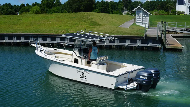 Slide: The Image of 2005 Parker 2501 Center Console boat with twin Yamaha engines on a calm waterway. - 3