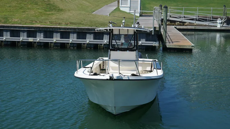 Slide: The Image of 2005 Parker 2501 Center Console boat docked in calm waters. - 4