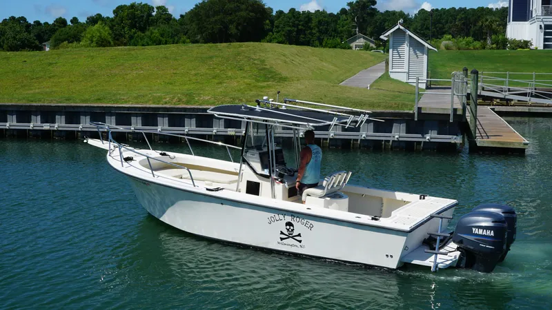 Slide: The Image of 2005 Parker 2501 Center Console boat with Yamaha engines on a calm waterway. - 5