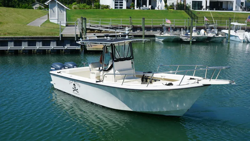 Slide: The Image of 2005 Parker 2501 Center Console boat docked in a marina with twin Yamaha engines. - 6