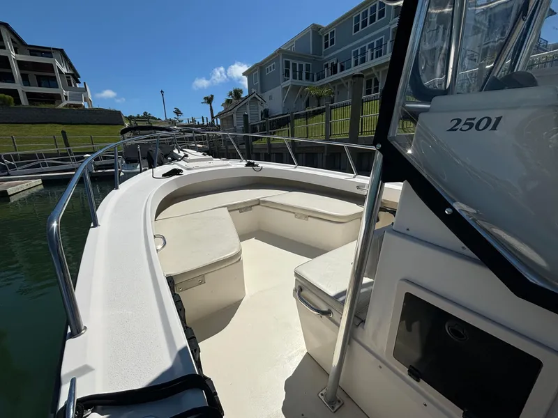 Slide: The Image of 2005 Parker 2501 Center Console boat docked near waterfront homes. - 9