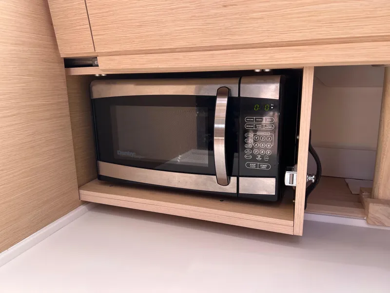 Slide: The Image of Microwave in Jeanneau 54 yacht's wooden cabinet, 2018 model. - 104