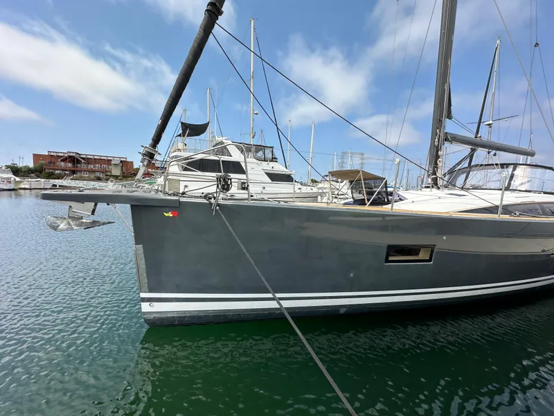 Slide: The Image of 2018 Jeanneau 54 yacht docked in marina, clear sky, calm water. - 14
