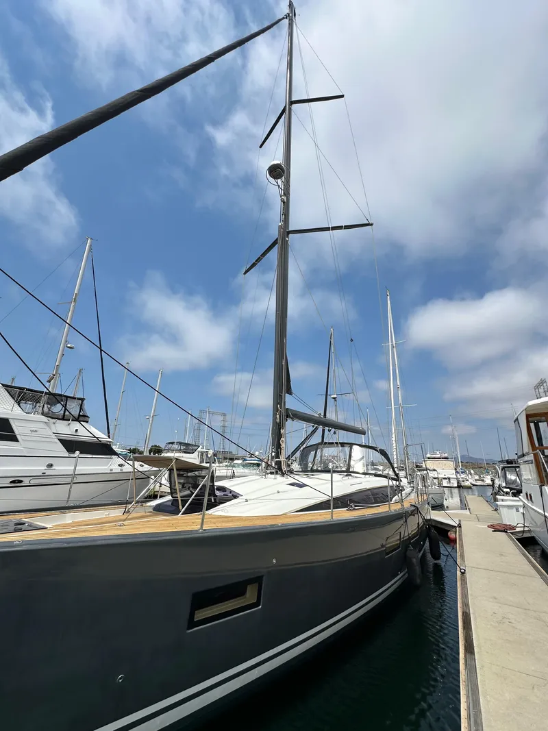 Slide: The Image of 2018 Jeanneau 54 yacht docked at marina under blue sky. - 15
