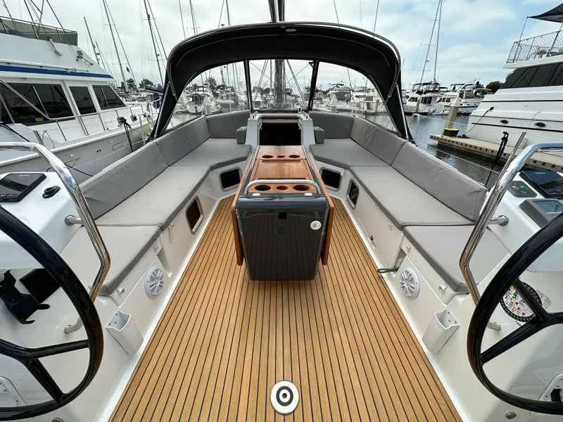 Slide: The Image of Spacious cockpit of a 2018 Jeanneau 54 yacht with elegant seating and wooden flooring. - 30