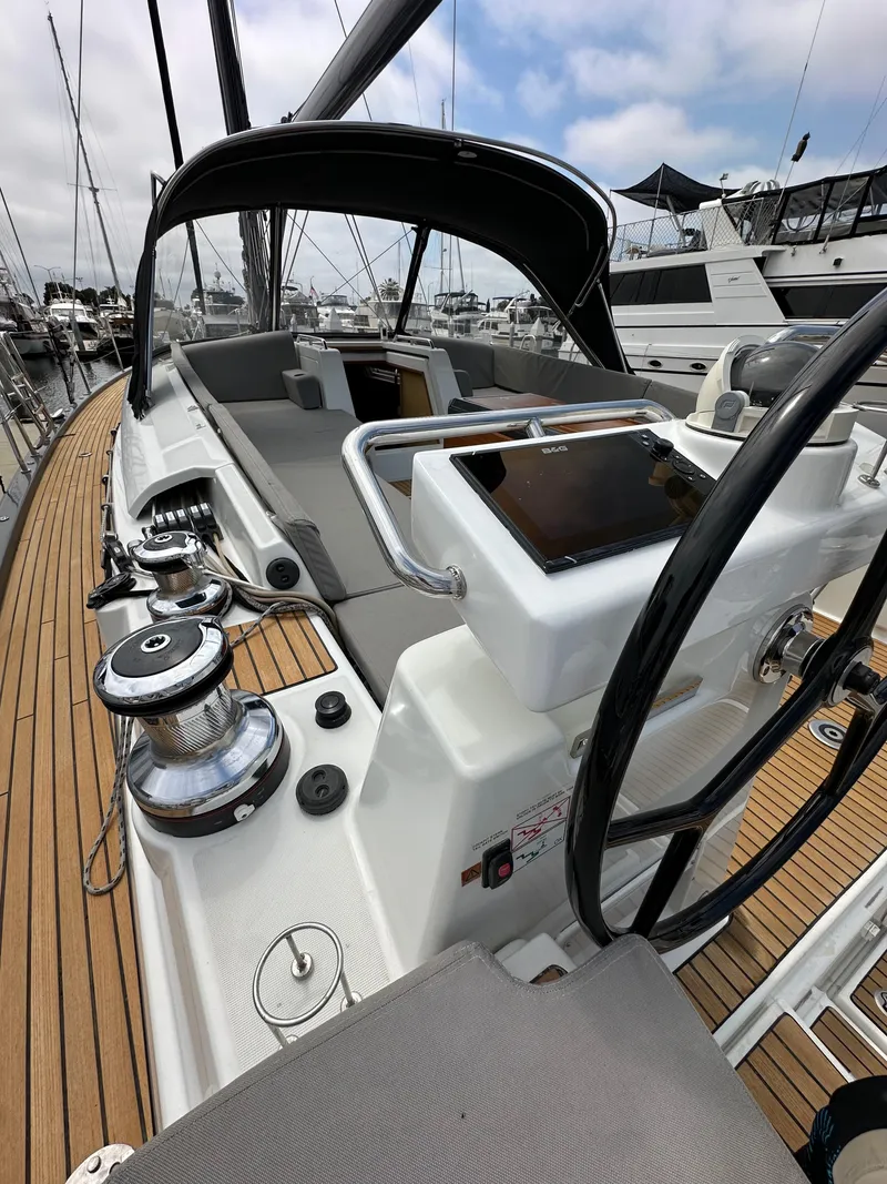 Slide: The Image of Cockpit of 2018 Jeanneau 54 sailboat with steering wheel and navigation equipment. - 32