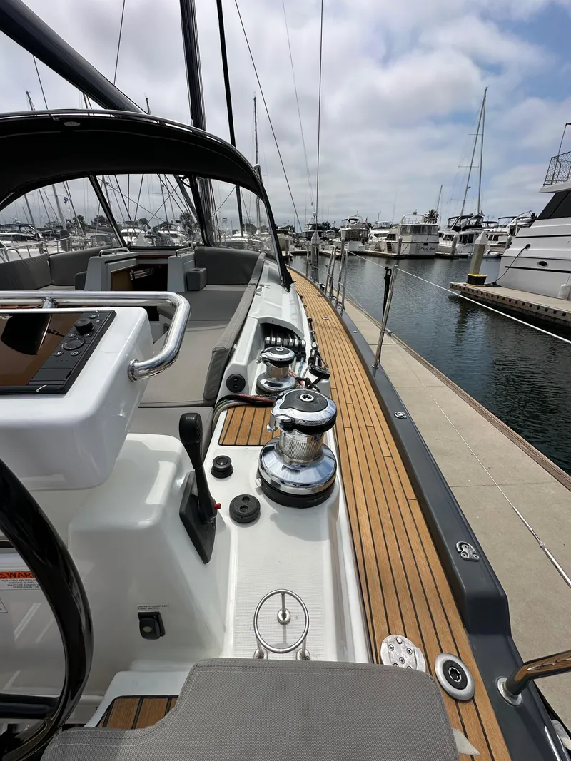 Slide: The Image of 2018 Jeanneau 54 yacht docked at marina, showcasing sleek deck and modern design. - 35
