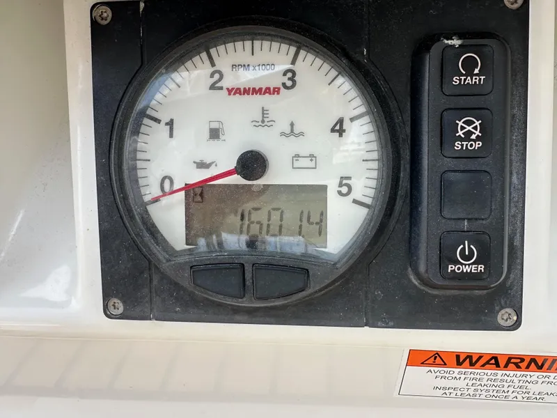 Slide: The Image of Control panel of a 2018 Jeanneau 54 sailboat with Yanmar tachometer and warning label. - 38