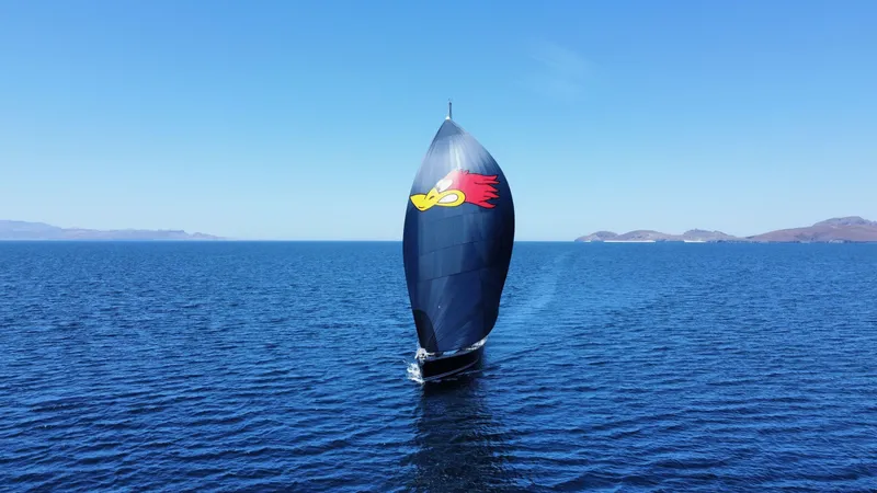 Slide: The Image of Sailing yacht Jeanneau 54 (2018) with colorful spinnaker on open sea. - 4