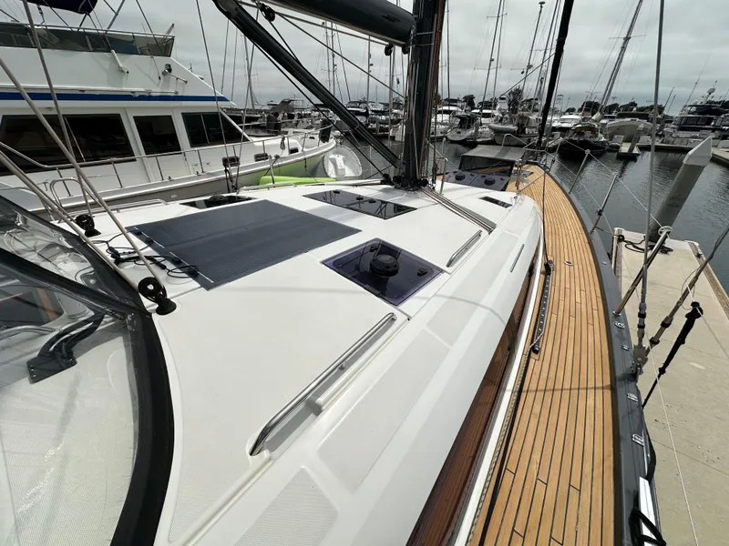 Slide: The Image of 2018 Jeanneau 54 yacht docked, showcasing sleek deck design and modern features. - 43