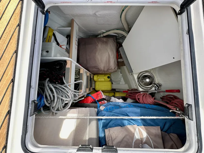 Slide: The Image of Storage compartment of a 2018 Jeanneau 54 sailboat with ropes and equipment. - 49