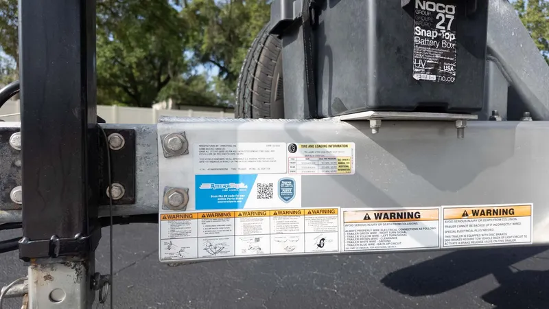 Slide: The Image of Trailer hitch with warning labels and battery box for 2025 Chris-Craft Catalina 28 boat. - 10