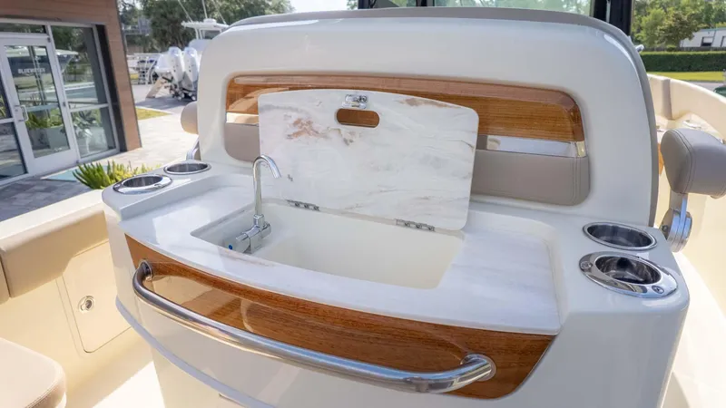 Slide: The Image of 2025 Chris-Craft Catalina 28 boat sink with wooden accents and cup holders. - 18