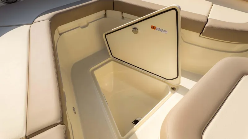 Slide: The Image of 2025 Chris-Craft Catalina 28 boat storage compartment with open hatch and cushioned seating. - 28