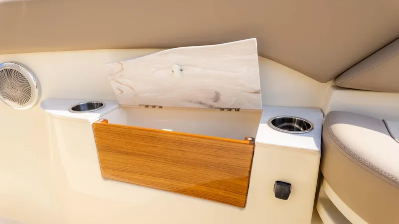 Slide: The Image of 2025 Chris-Craft Catalina 28 interior detail with cup holders and storage compartment. - 29