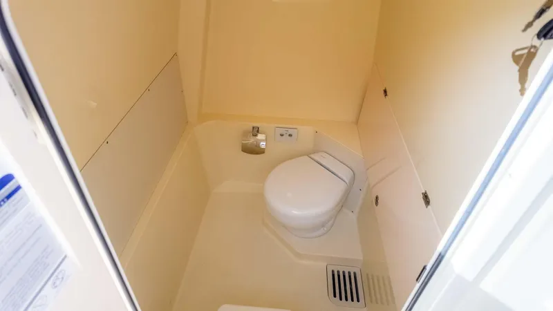 Slide: The Image of 2025 Chris-Craft Catalina 28 boat bathroom interior with compact toilet and storage. - 30