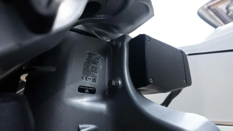 Slide: The Image of Close-up of 2025 Chris-Craft Catalina 28 engine component with labels and screws. - 8