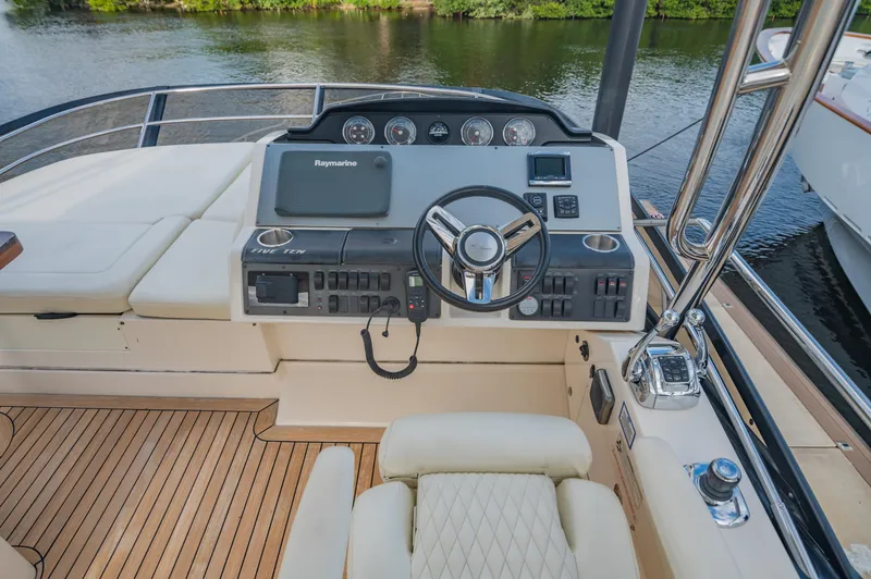Slide: The Image of 2015 Sea Ray 510 Fly yacht helm with luxurious seating and advanced controls. - 24