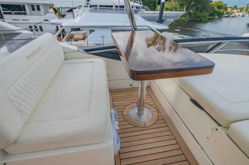 Slide: The Image of Luxurious 2015 Sea Ray 510 Fly yacht deck with elegant seating and polished wood table. - 25