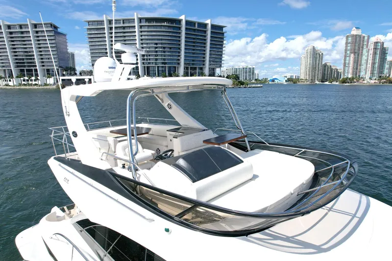 Slide: The Image of 2015 Sea Ray 510 Fly yacht on water with city skyline background. - 3