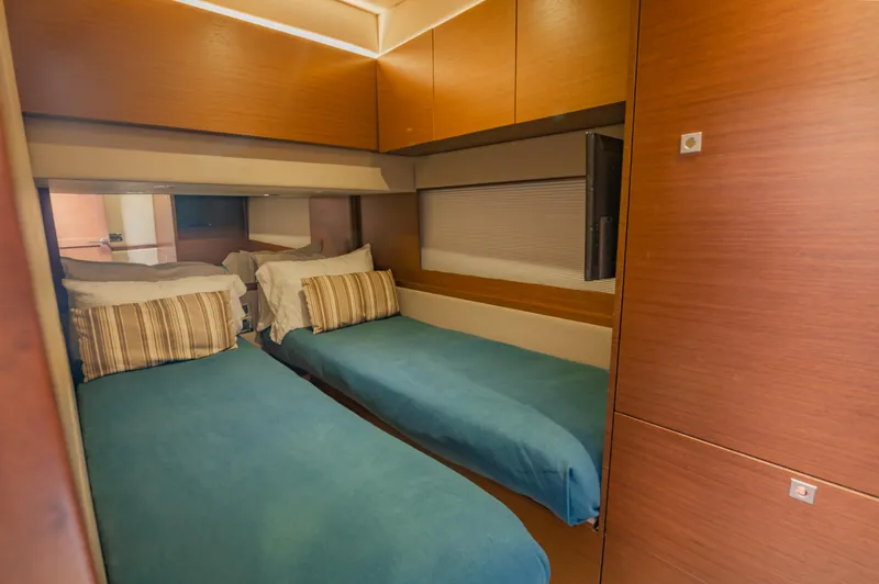 Slide: The Image of 2015 Sea Ray 510 Fly cabin with twin beds and modern wood paneling. - 32