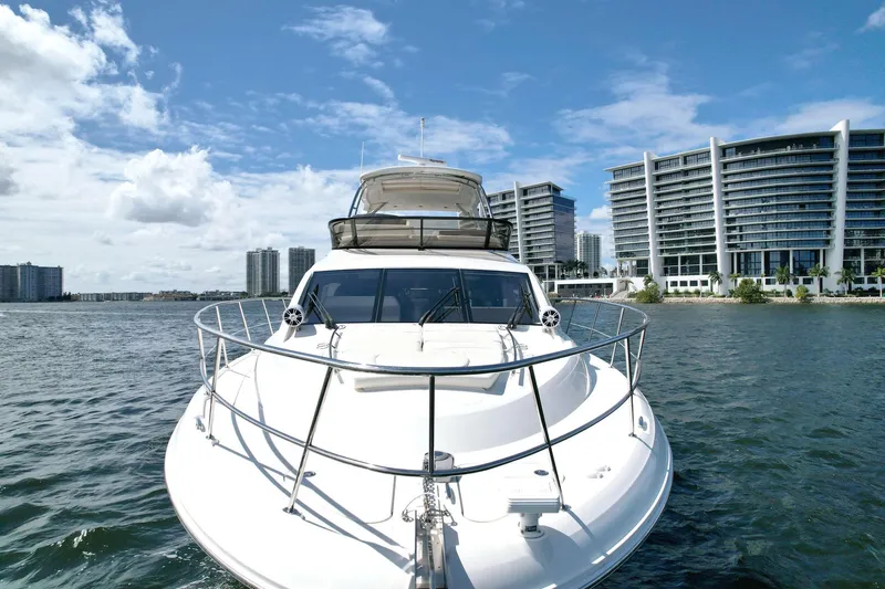 Slide: The Image of Sea Ray 510 Fly 2015 yacht cruising near modern waterfront buildings under blue sky. - 4