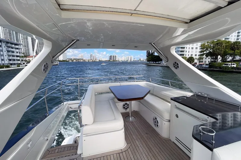 Slide: The Image of Luxurious 2015 Sea Ray 510 Fly yacht with spacious deck and scenic waterfront view. - 6