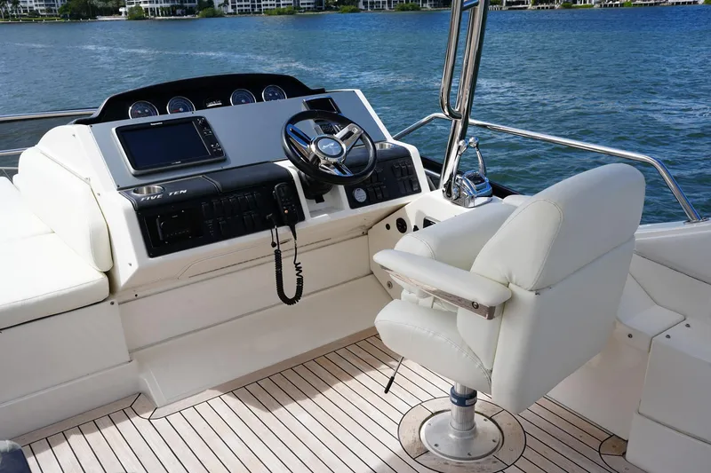 Slide: The Image of 2015 Sea Ray 510 Flybridge helm with modern controls and comfortable seating. - 7