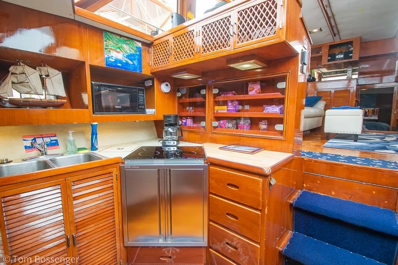 Slide: The Image of Luxurious 1987 Lien Hwa 47 Elegant MKII Motoryacht kitchen with wooden cabinetry and modern appliances. - 16