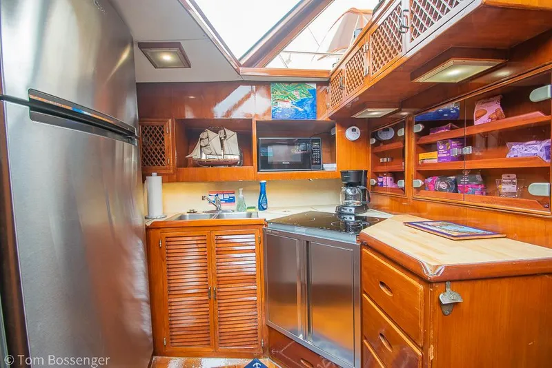 Slide: The Image of 1987 Lien Hwa 47 Elegant MKII Motoryacht kitchen with wooden cabinetry and modern appliances. - 18