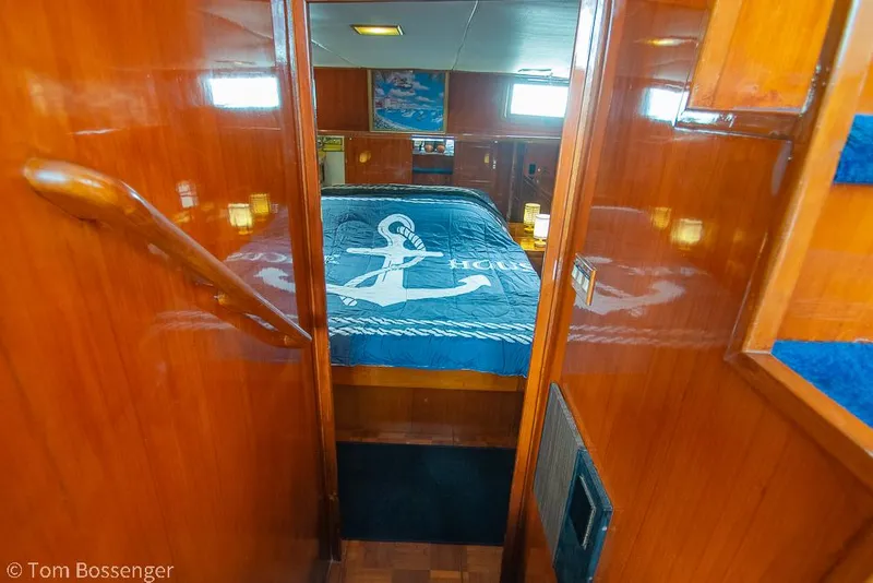 Slide: The Image of Interior of 1987 Lien Hwa 47 Elegant MKII Motoryacht with wooden paneling and nautical-themed bedding. - 23