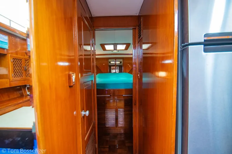 Slide: The Image of Interior of 1987 Lien Hwa 47 Elegant MKII Motoryacht with wooden cabinetry and teal bedding. - 32