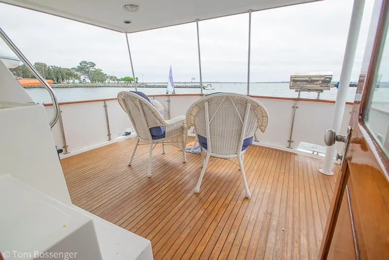 Slide: The Image of 1987 Lien Hwa 47 Elegant MKII Motoryacht deck with wicker chairs overlooking the water. - 38