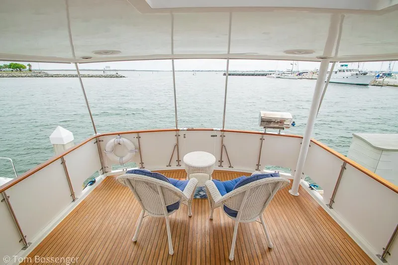 Slide: The Image of 1987 Lien Hwa 47 Elegant MKII Motoryacht deck with chairs overlooking serene waters. - 41