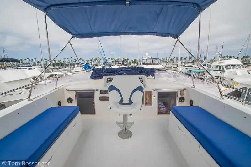 Slide: The Image of 1987 Lien Hwa 47 Elegant MKII Motoryacht helm with blue seating and canopy in marina. - 44