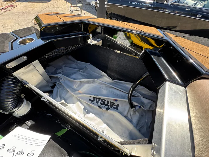 Slide: The Image of Open storage compartment in a 2025 Centurion RI 245 boat, showing interior details. - 12