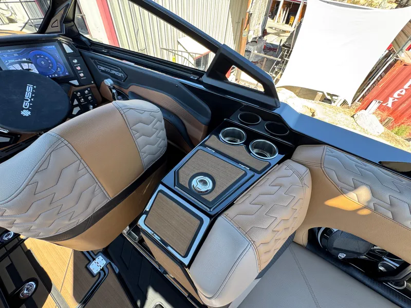 Slide: The Image of Interior of 2025 Centurion RI 245 boat with modern dashboard and luxurious seating. - 16
