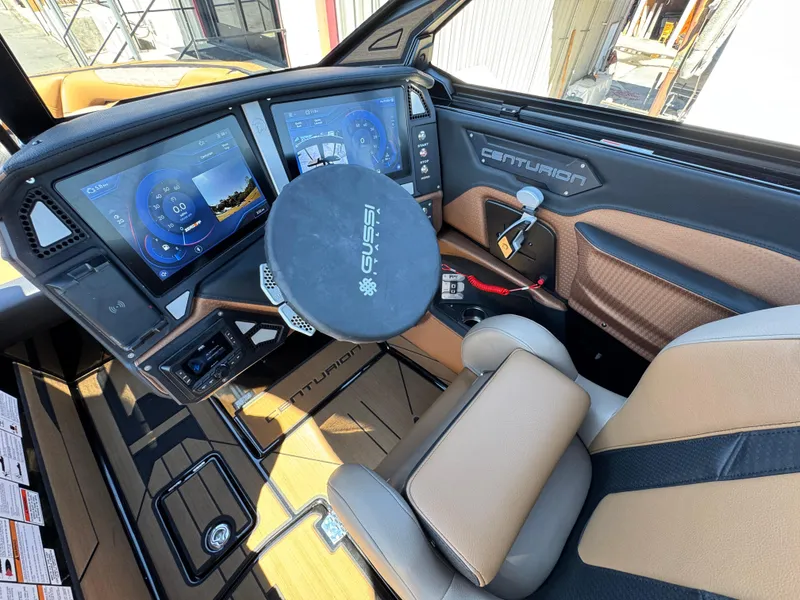 Slide: The Image of 2025 Centurion RI 245 boat dashboard with advanced digital displays and steering wheel. - 17