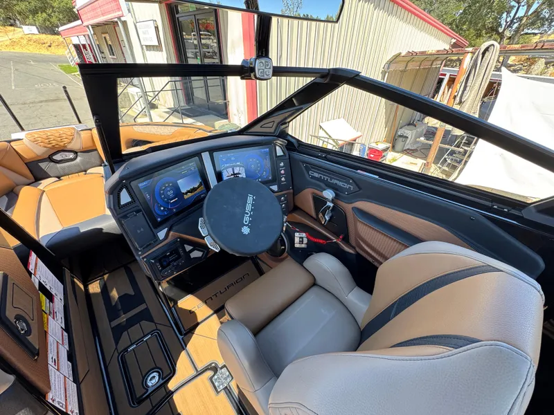 Slide: The Image of Interior of 2025 Centurion RI 245 boat with modern dashboard and steering wheel. - 18