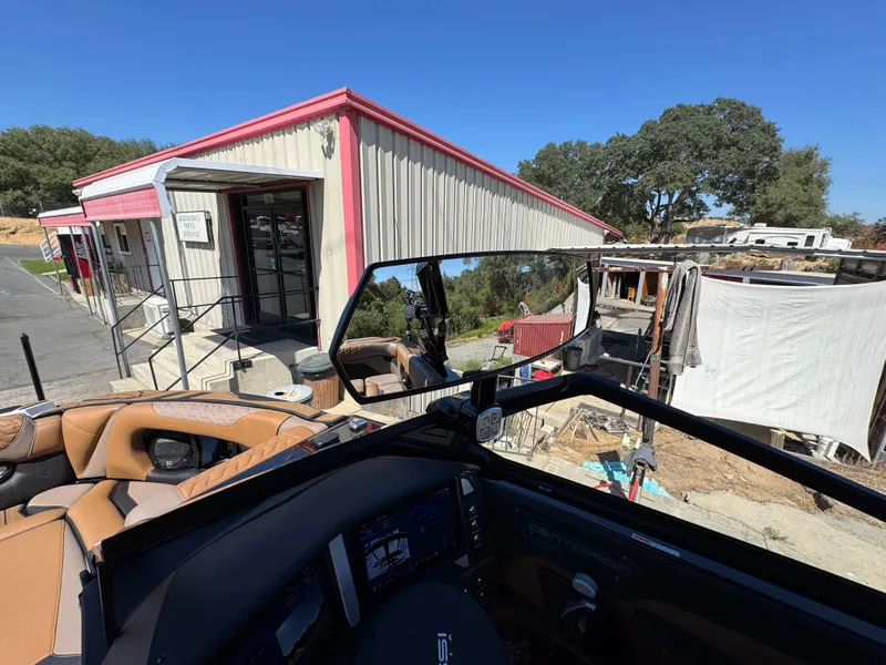 Slide: The Image of Interior view of a 2025 Centurion RI 245 boat near a service building. - 19