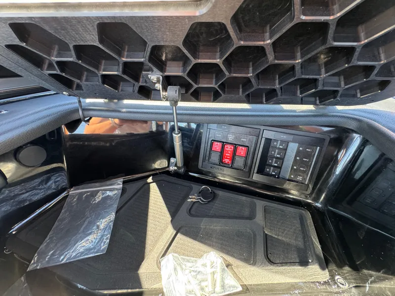 Slide: The Image of 2025 Centurion RI 245 boat interior with control panel and storage compartment. - 23